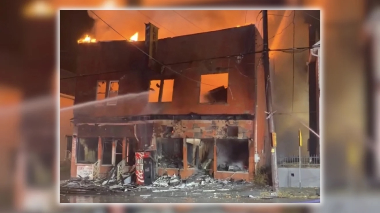 Firefighters battling flames at a building in Old Forge